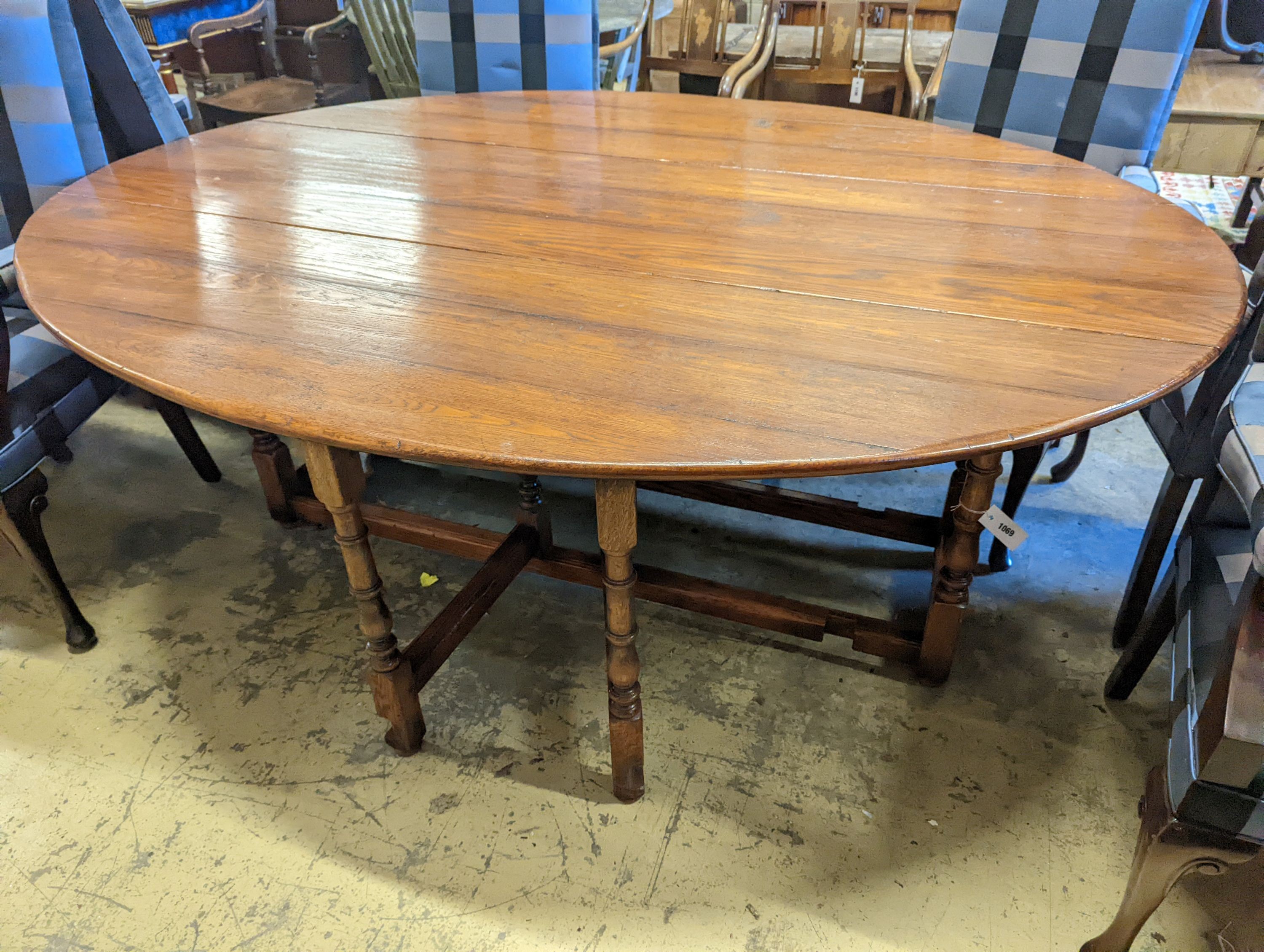 An 18th century style oak gateleg 'wake' dining table, length 200cm, 150cm extended, height 75cm